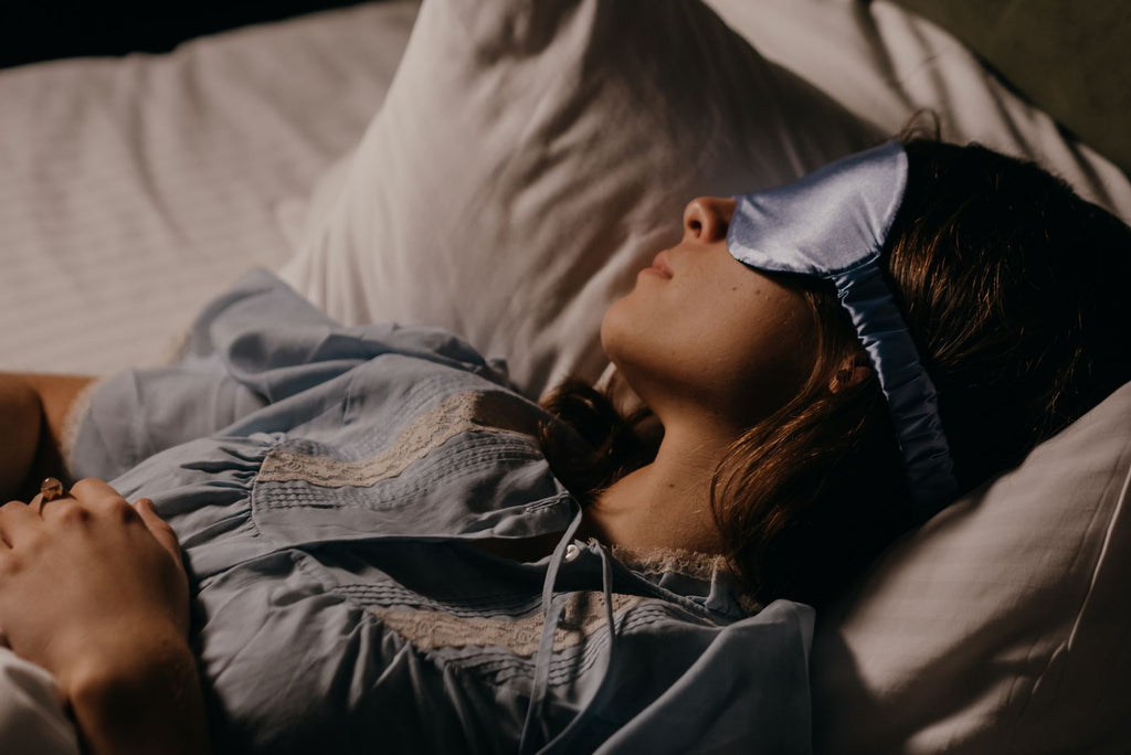 A person resting peacefully at night in a softly lit bedroom
